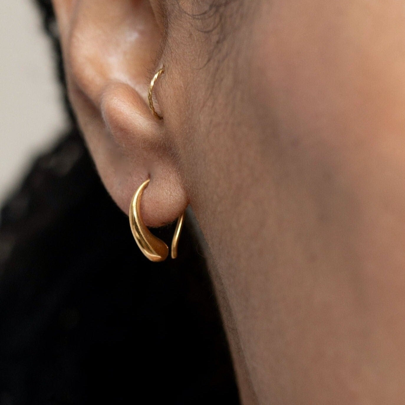 tiny raindrop earrings in gold.